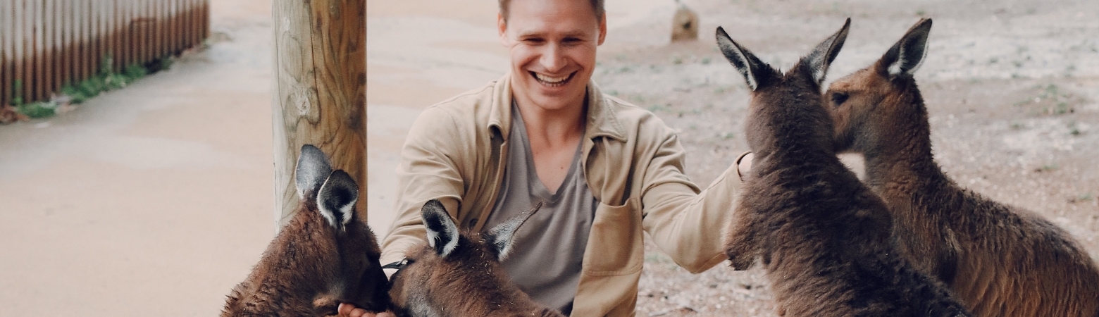 Man feeding the kangaroos